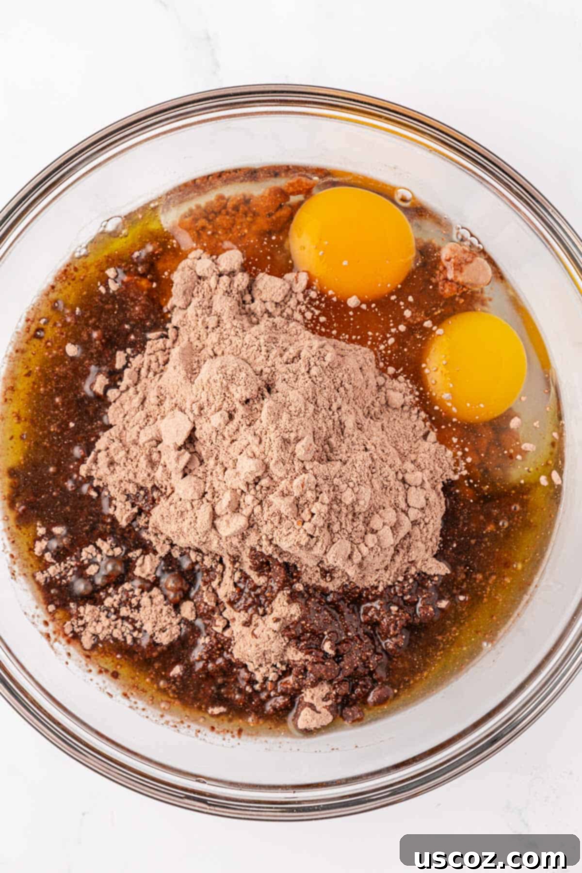 Decadent Chocolate Cake Mix Cookies 5 eggs, oil, and cake mix in a mixing bowl before being combined
