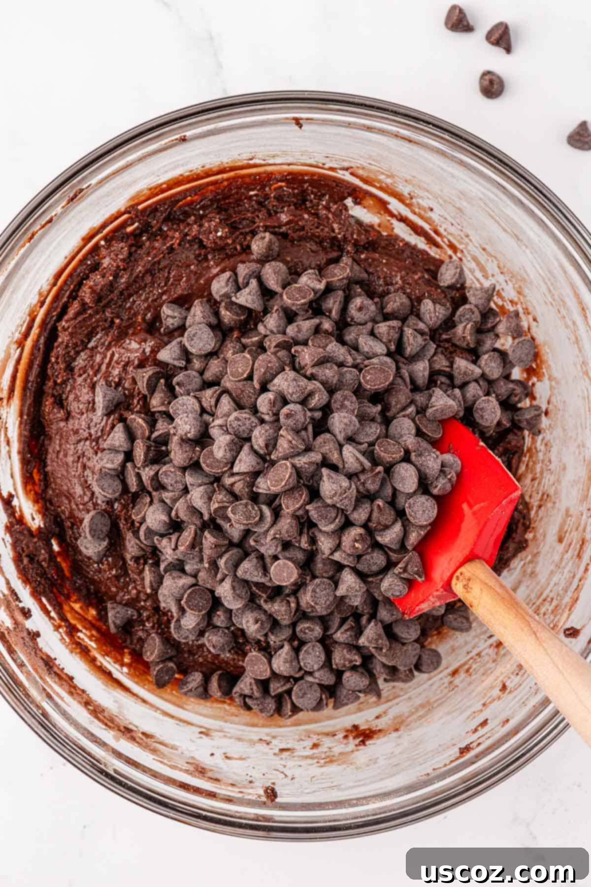 Decadent Chocolate Cake Mix Cookies 7 adding semi-sweet chocolate chips to the mixed chocolate cookie batter