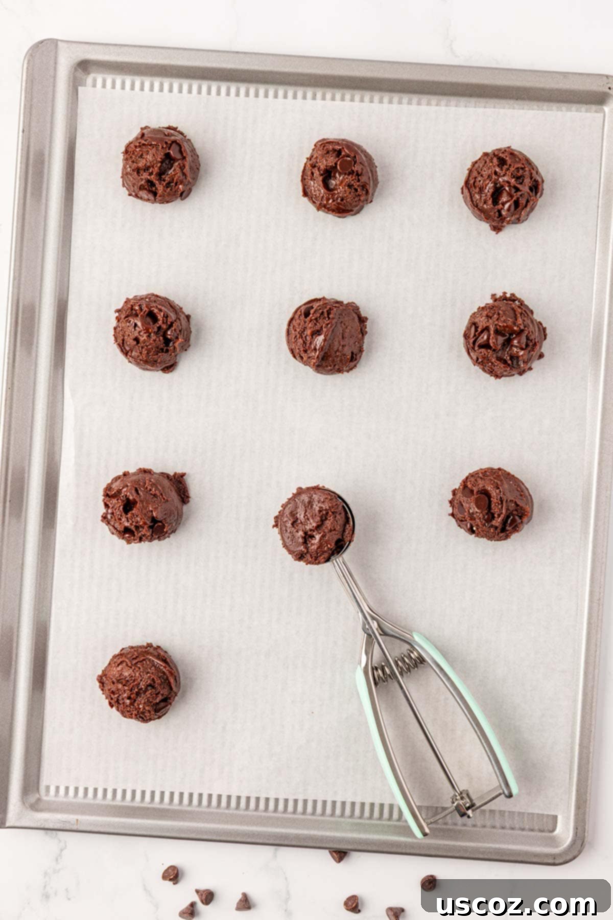 Decadent Chocolate Cake Mix Cookies 9 using a mini cookie scoop to portion dough onto a parchment-lined baking sheet