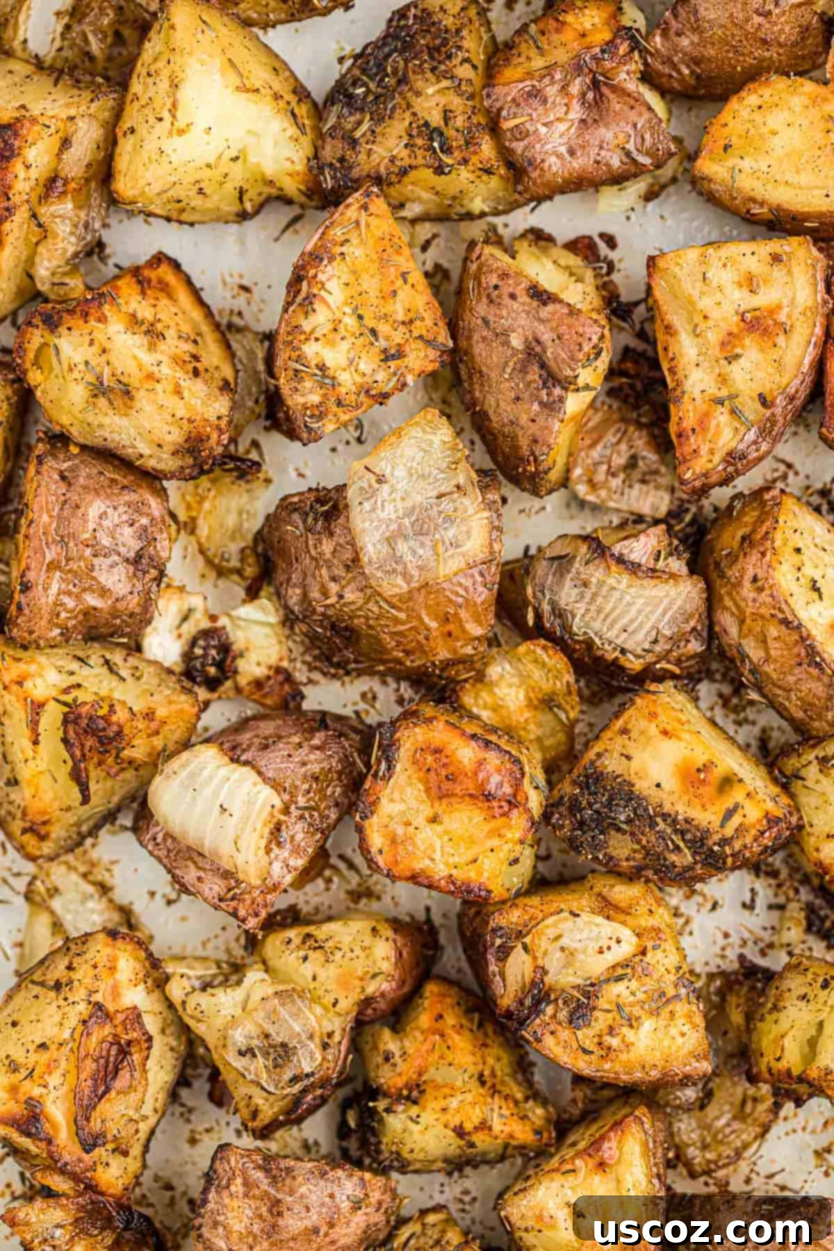 Caramelized Onion and Potato Medley 3 Close-up of golden brown roasted potatoes, fresh out of the oven.