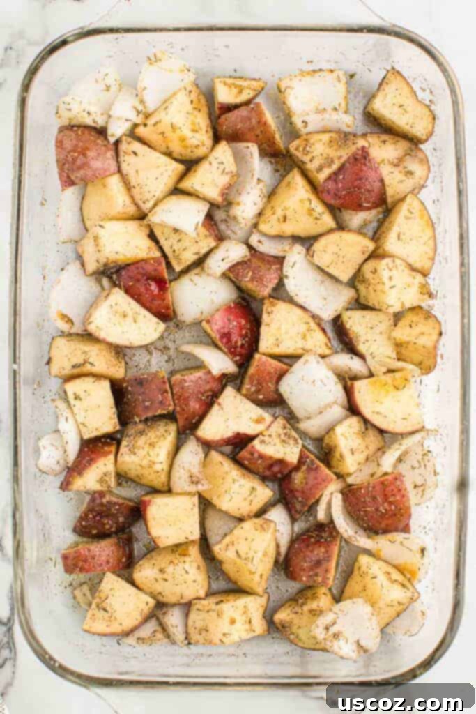 Caramelized Onion and Potato Medley 9 Roasted potatoes and onions browning in a baking dish, halfway through cooking.