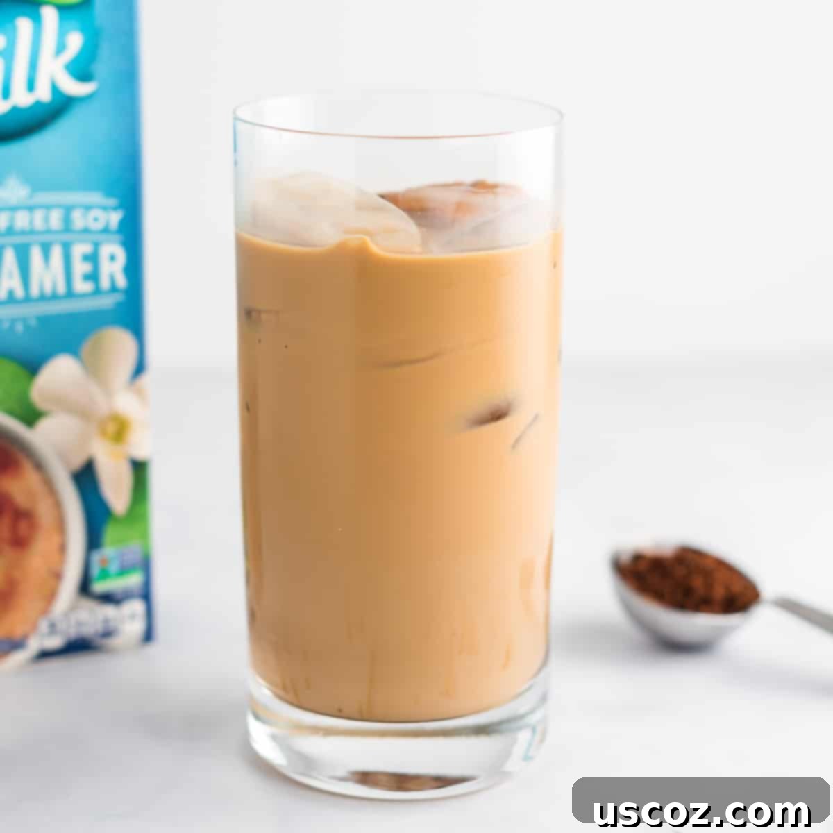 Effortless Instant Iced Coffee 2 A refreshing glass of instant iced coffee with ice cubes and a spoon, ready to drink.