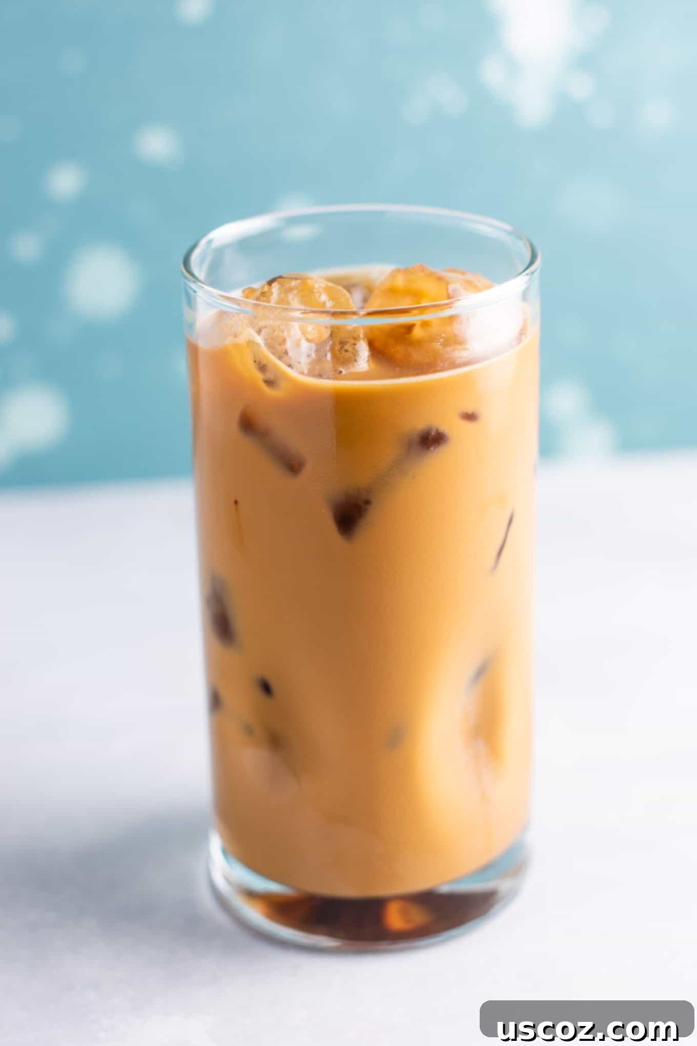 Effortless Instant Iced Coffee 3 A person stirring instant coffee granules into cold water in a glass, demonstrating how to make iced coffee with instant coffee.