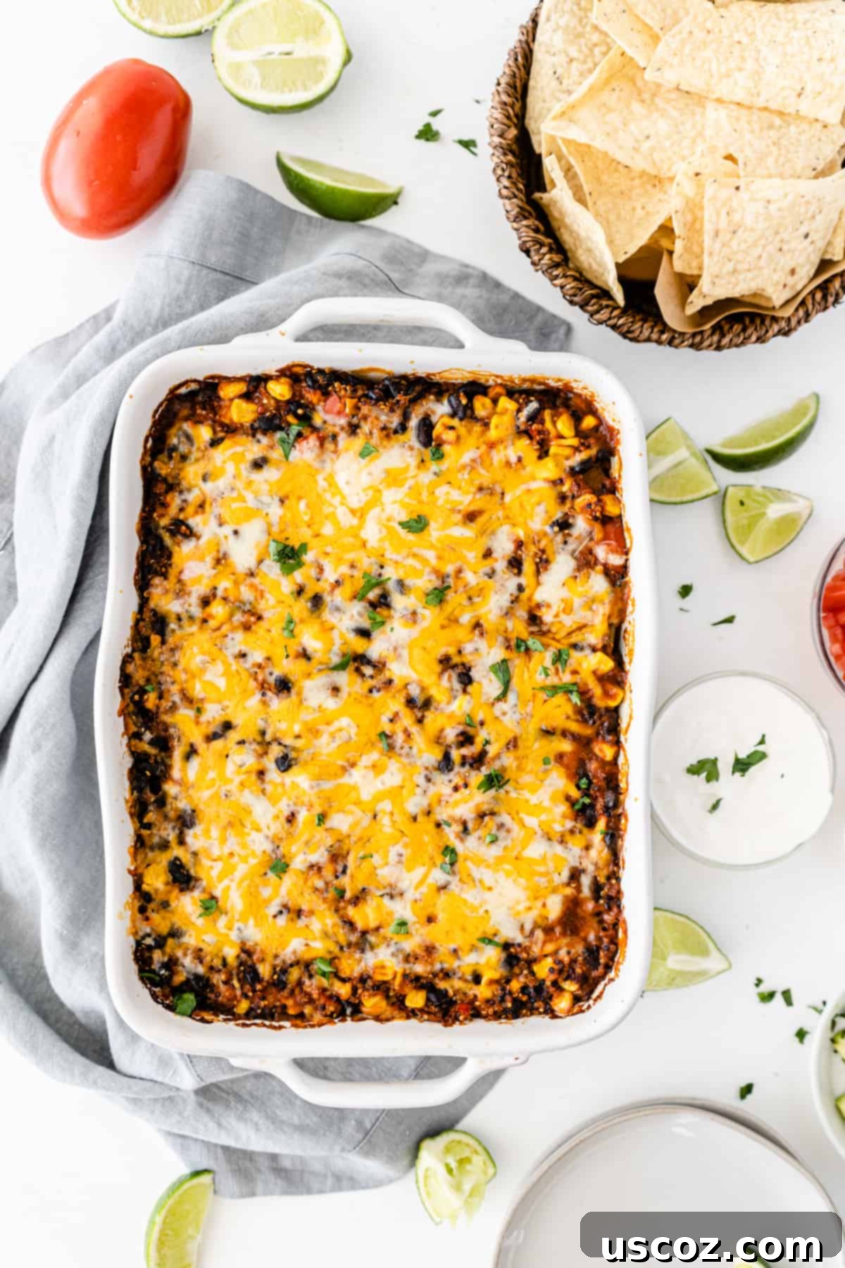 Wholesome Quinoa Enchilada Bake 8 A large white baking dish filled with savory Mexican quinoa casserole, fresh from the oven, showcasing its golden, bubbly cheese topping.