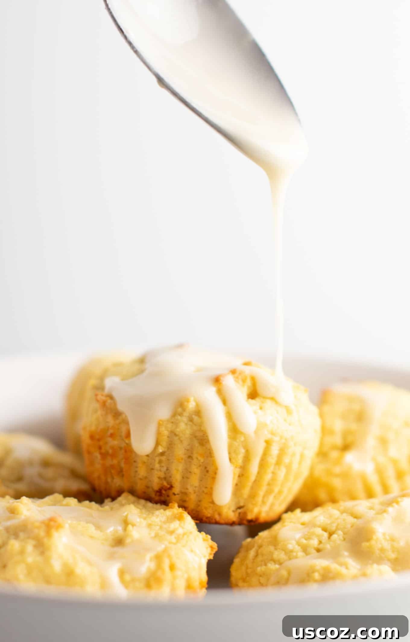 Zesty Gluten Free Lemon Muffins 6 Gluten-free lemon muffins drizzled with a fresh sweet lemon glaze, highlighting their golden color and tempting appearance. #glutenfree #lemonmuffins #breakfast