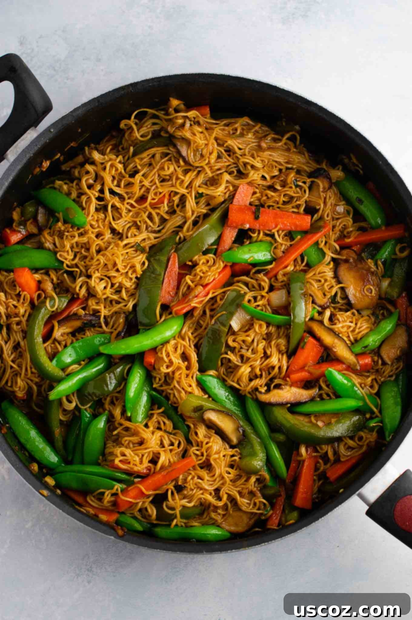 Sizzling Ramen Stir-Fry 13 A large serving of ramen noodle stir fry with golden oak shiitake mushrooms, sugar snap peas, green bell pepper, carrots, green onions, and fresh garlic and ginger.