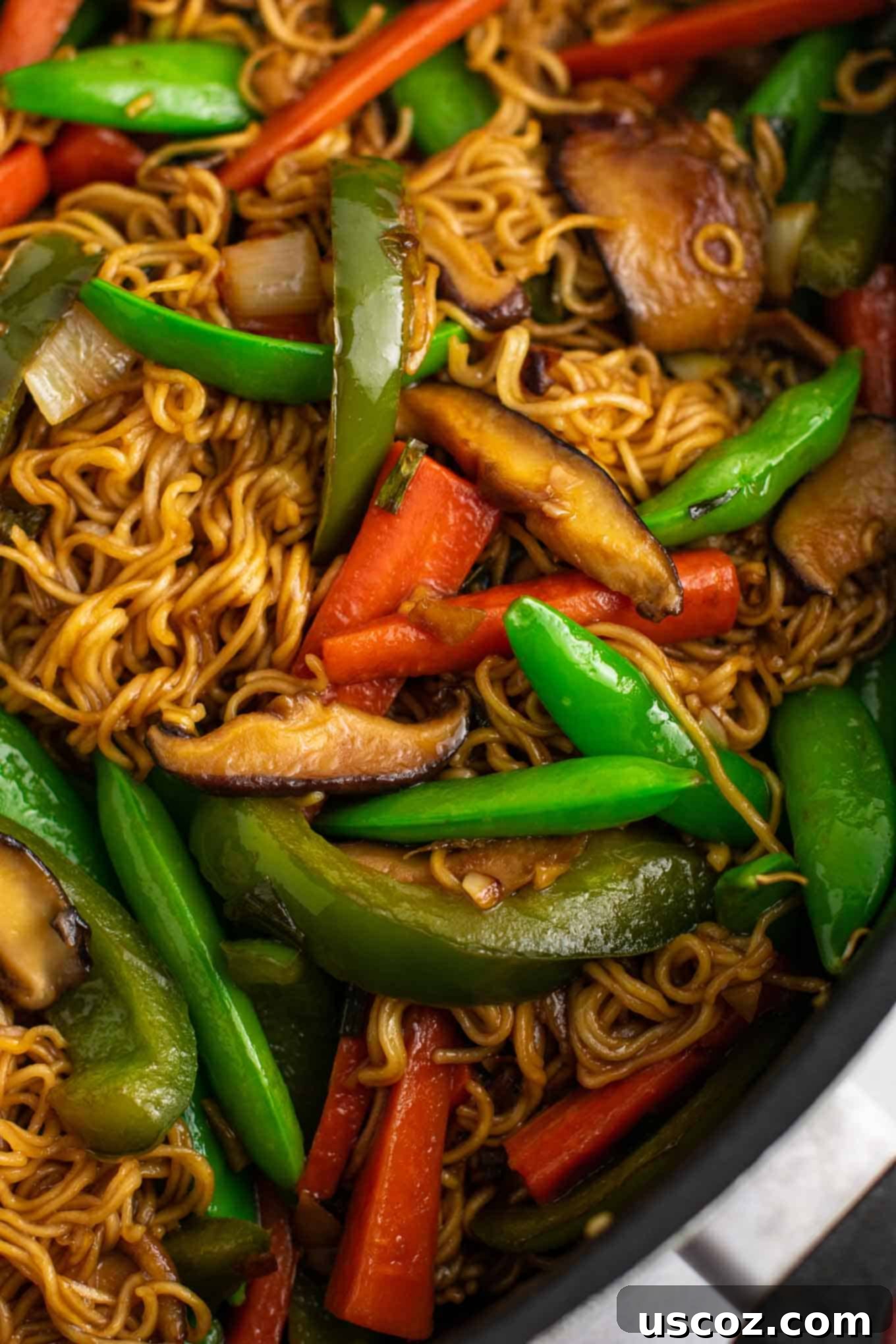 Sizzling Ramen Stir-Fry 7 Vegetable stir fry noodles recipe being tossed in a large pan