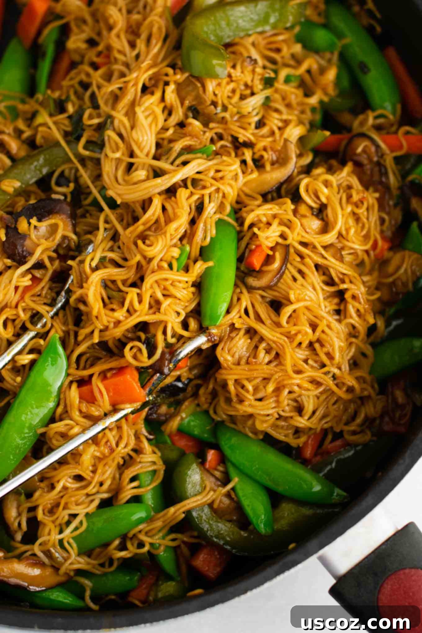 Sizzling Ramen Stir-Fry 9 Close-up of Ramen noodle stir fry with golden oak shiitake mushrooms, sugar snap peas, green bell pepper, carrots, green onions, and fresh garlic and ginger, ready to serve.