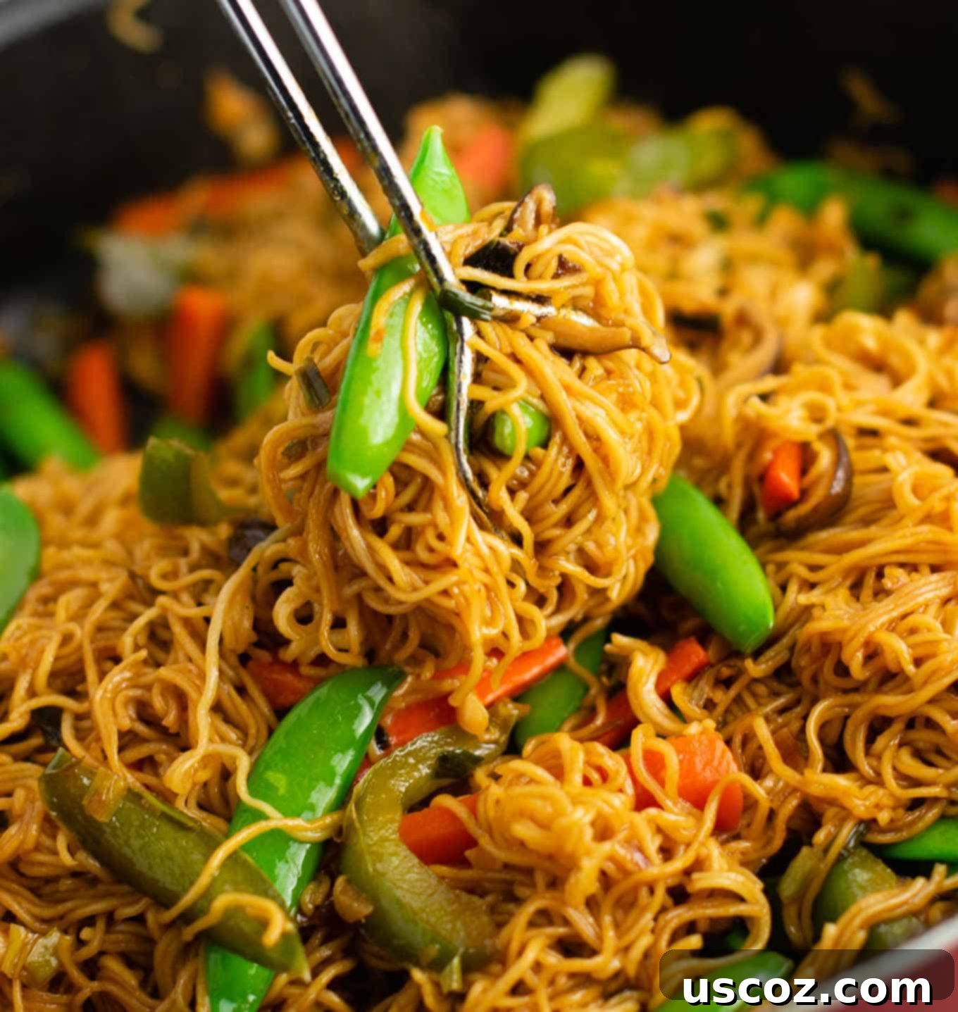 Sizzling Ramen Stir-Fry 10 A vibrant bowl of ramen noodles with sugar snap peas, carrots, and bell pepper, showcasing the fresh vegetables.