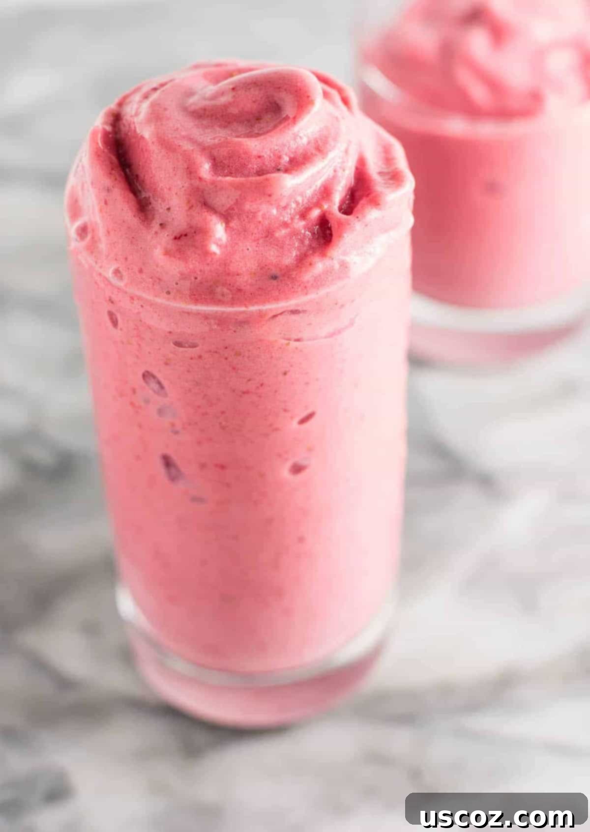 Sip into Summer: 11 Refreshing Smoothie Recipes 2 A vibrant strawberry banana smoothie in a clear glass, perfect for a hot summer day.