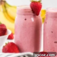 Sip into Summer: 11 Refreshing Smoothie Recipes 6 Thick and creamy strawberry banana smoothie served in a mason jar, garnished with a fresh strawberry.