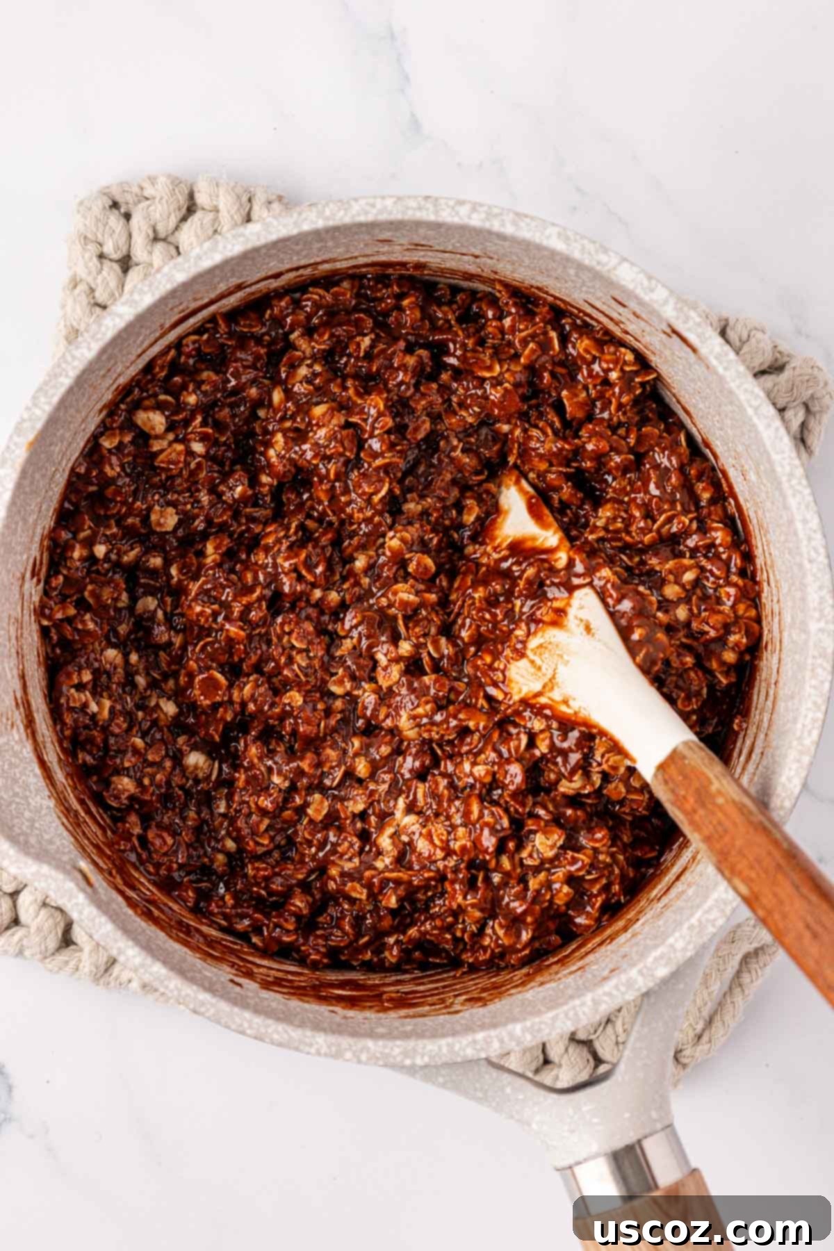 Wholesome No Bake Delights 11 No-bake cookie filling with oats mixed together in a saucepan