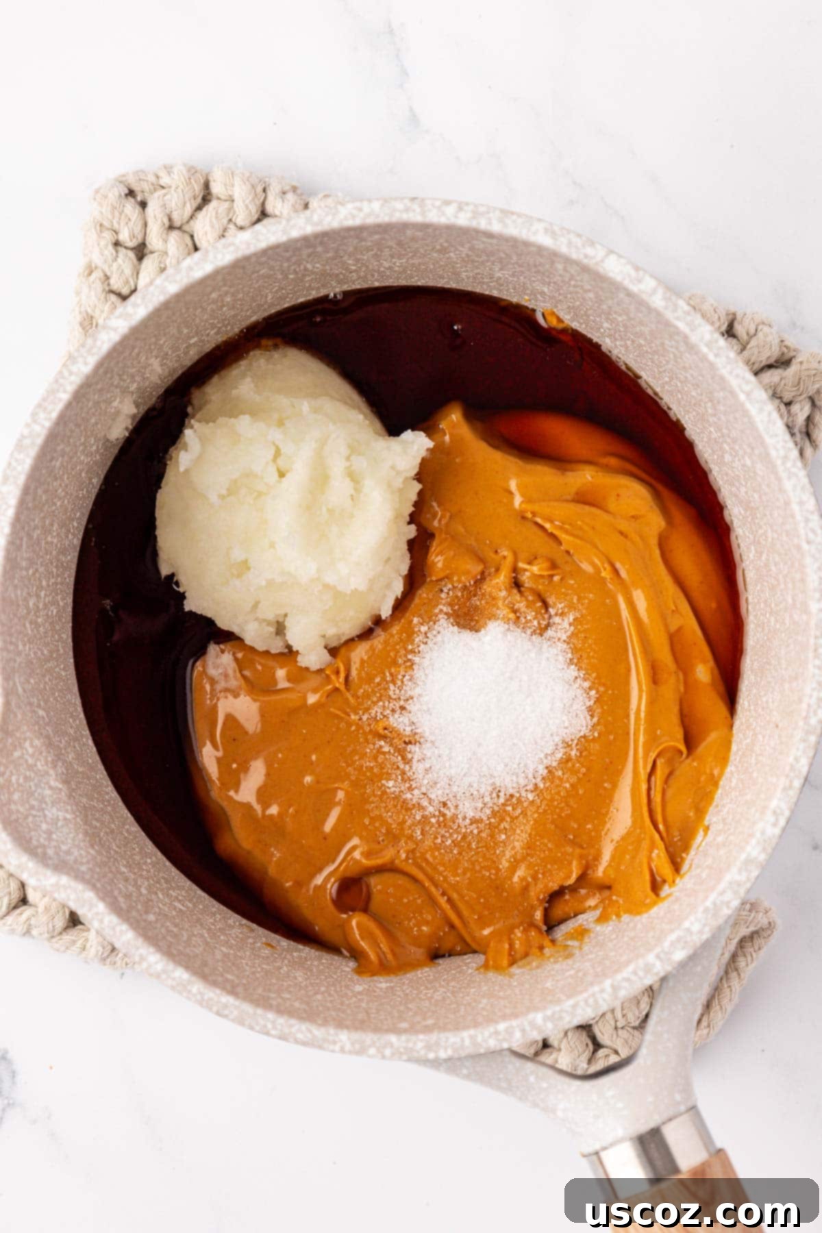 Wholesome No Bake Delights 5 Adding peanut butter, maple syrup, coconut oil, and salt to a saucepan