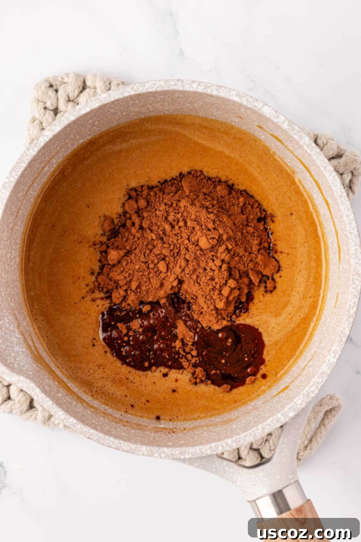 Wholesome No Bake Delights 7 Adding raw cacao powder to the melted peanut butter mixture