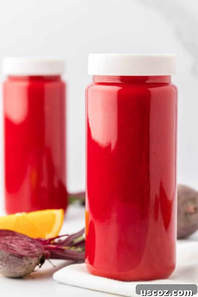 Ruby Root Refresher 11 A glass storage bottle filled with beet and carrot juice, capped with a lid