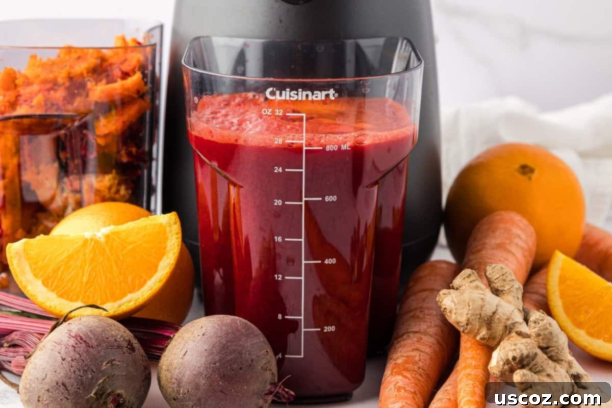 Ruby Root Refresher 3 Freshly extracted beet and carrot juice collecting in the juicer's canister