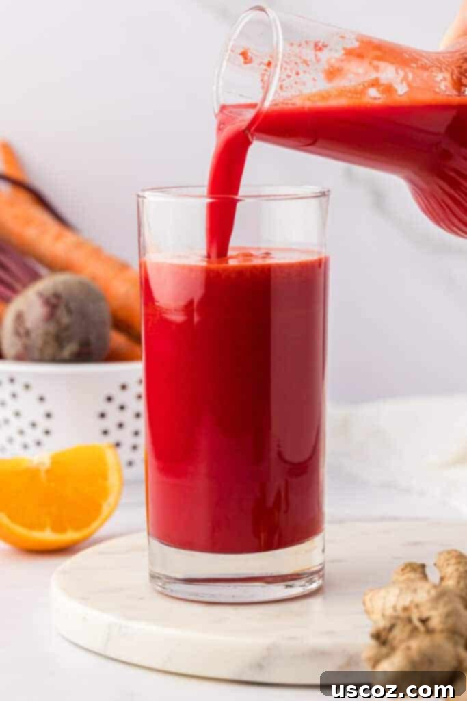 Ruby Root Refresher 7 Pouring fresh beet and carrot juice into a serving glass