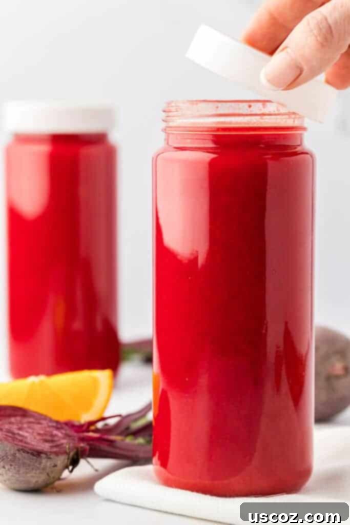 Ruby Root Refresher 10 Beet and carrot juice in a glass storage bottle