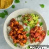 Easy enchilada tofu burrito bowls with homemade guacamole and salsa. Bring chipotle to your kitchen with this delicious recipe! #vegan #burritobowls #tofuburritobowls