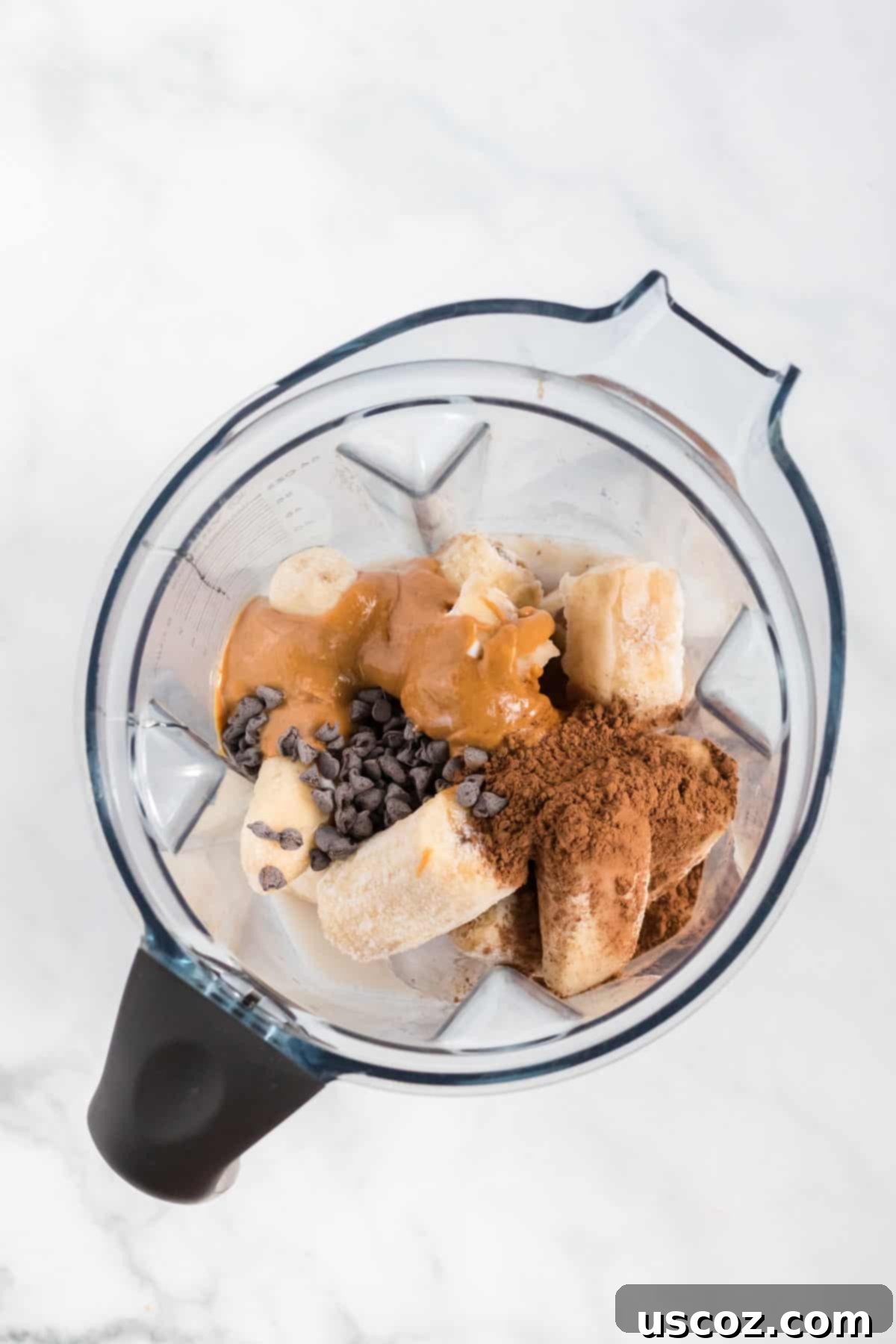 Indulgent Chocolate Peanut Butter Banana Smoothie 5 all ingredients, including frozen bananas and peanut butter, inside the blender container before blending