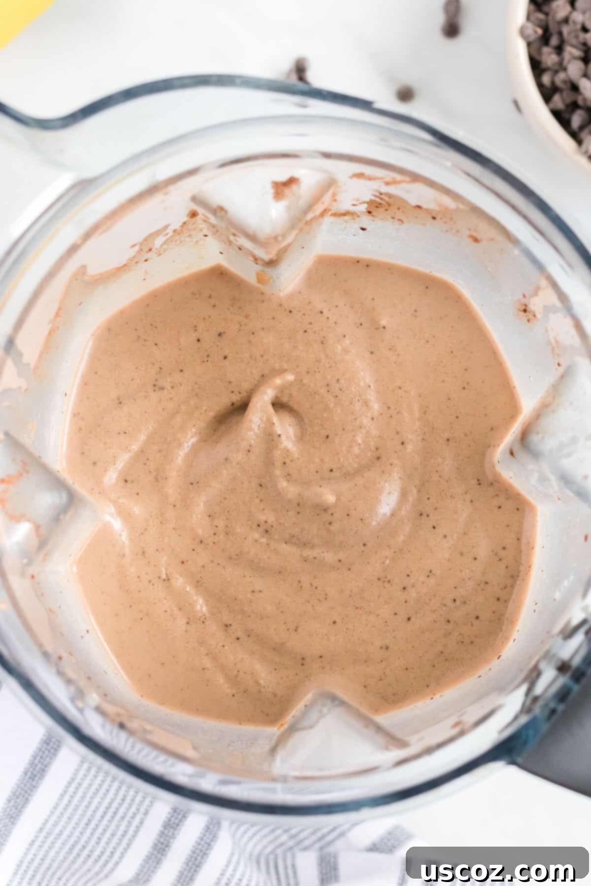 Indulgent Chocolate Peanut Butter Banana Smoothie 6 blender filled with a creamy chocolate peanut butter banana smoothie, viewed from an overhead perspective
