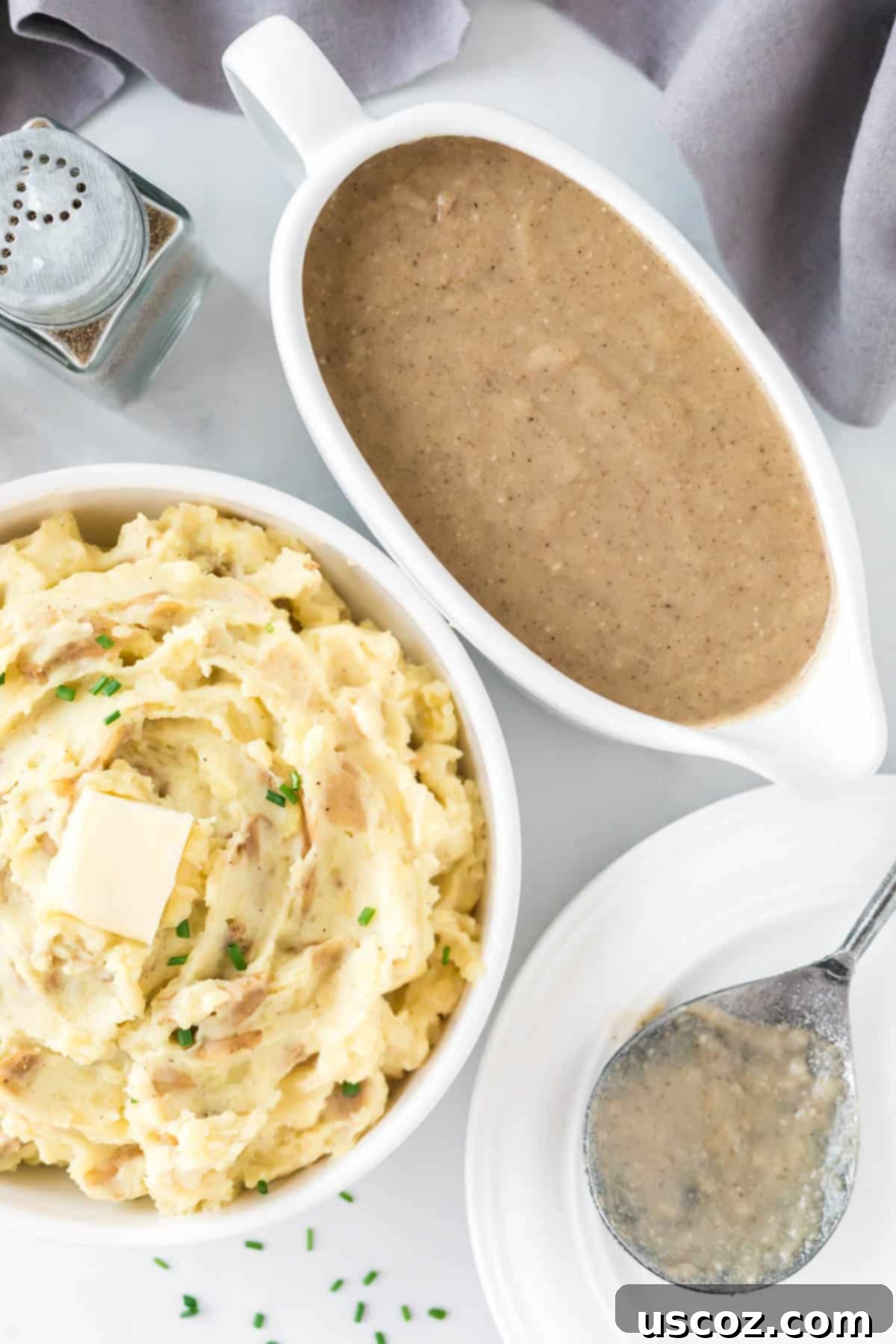 Tangy Mashed Potatoes 12 mashed potatoes in a bowl topped with butter next to a gravy boat