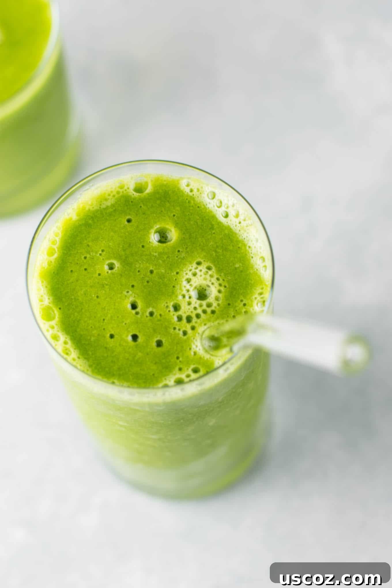 Overhead view of a vibrant green smoothie in a clear glass, perfect for a healthy start to the day.