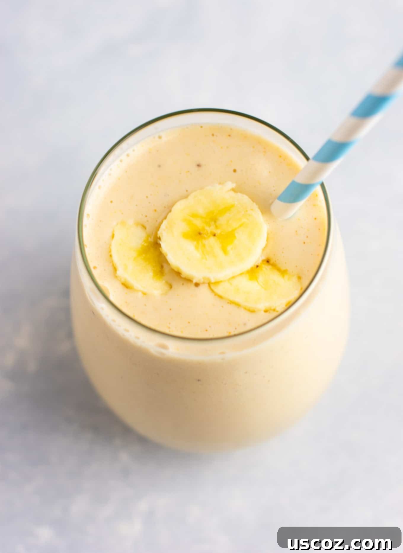 Creamy peanut butter banana smoothie topped with sliced banana, perfect for a wholesome breakfast.