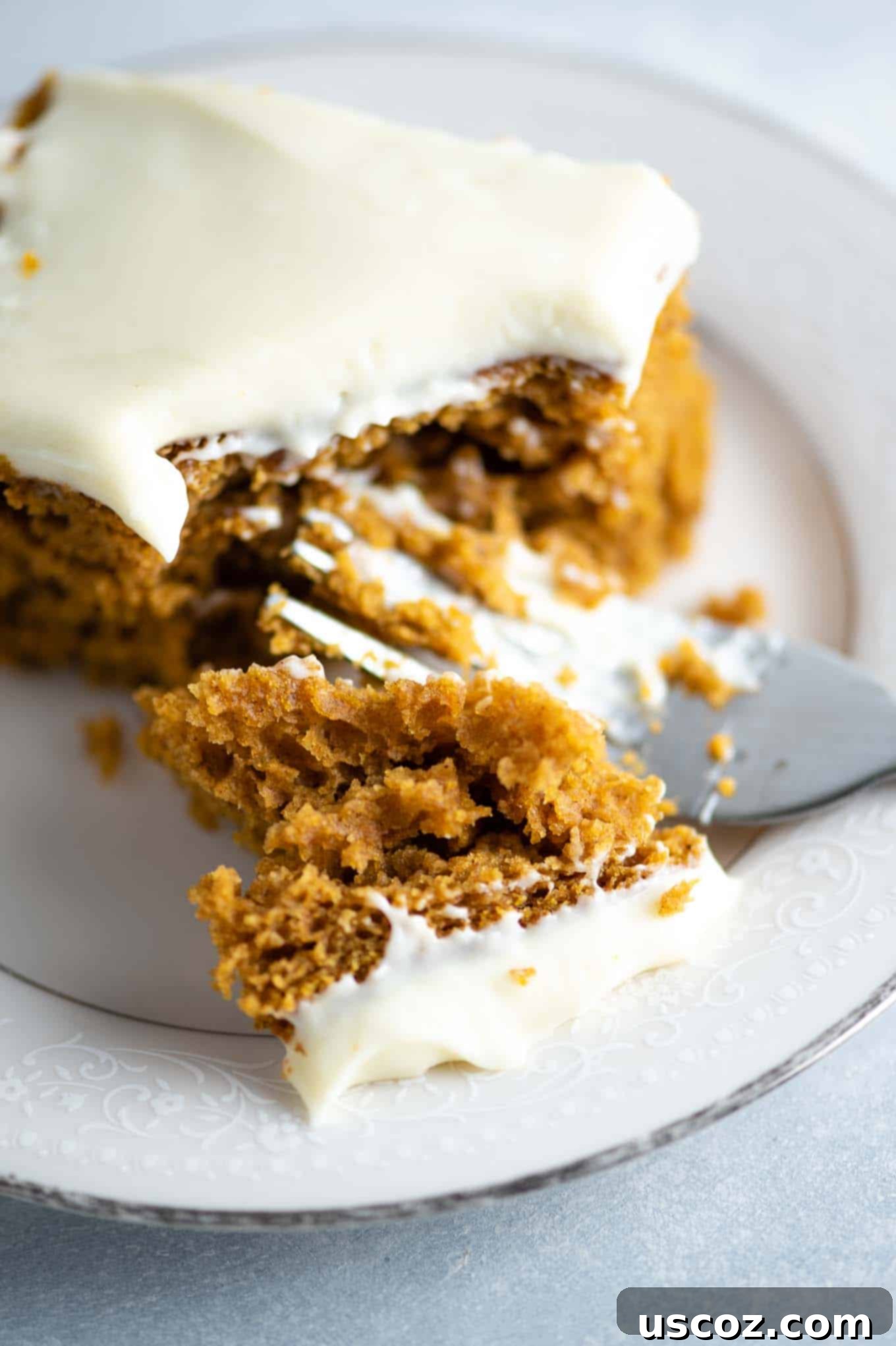 Decadent Pumpkin Cake with Cream Cheese Frosting 8 up close image of a bite of cake with frosting on it, showing fluffy texture