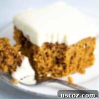 Decadent Pumpkin Cake with Cream Cheese Frosting 10 pumpkin cake recipe with cream cheese frosting slice with a bite taken out on a fork