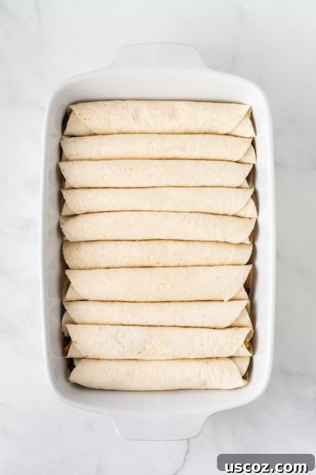 Irresistible Vegetarian Enchiladas 12 large baking dish filled with rolled up enchiladas