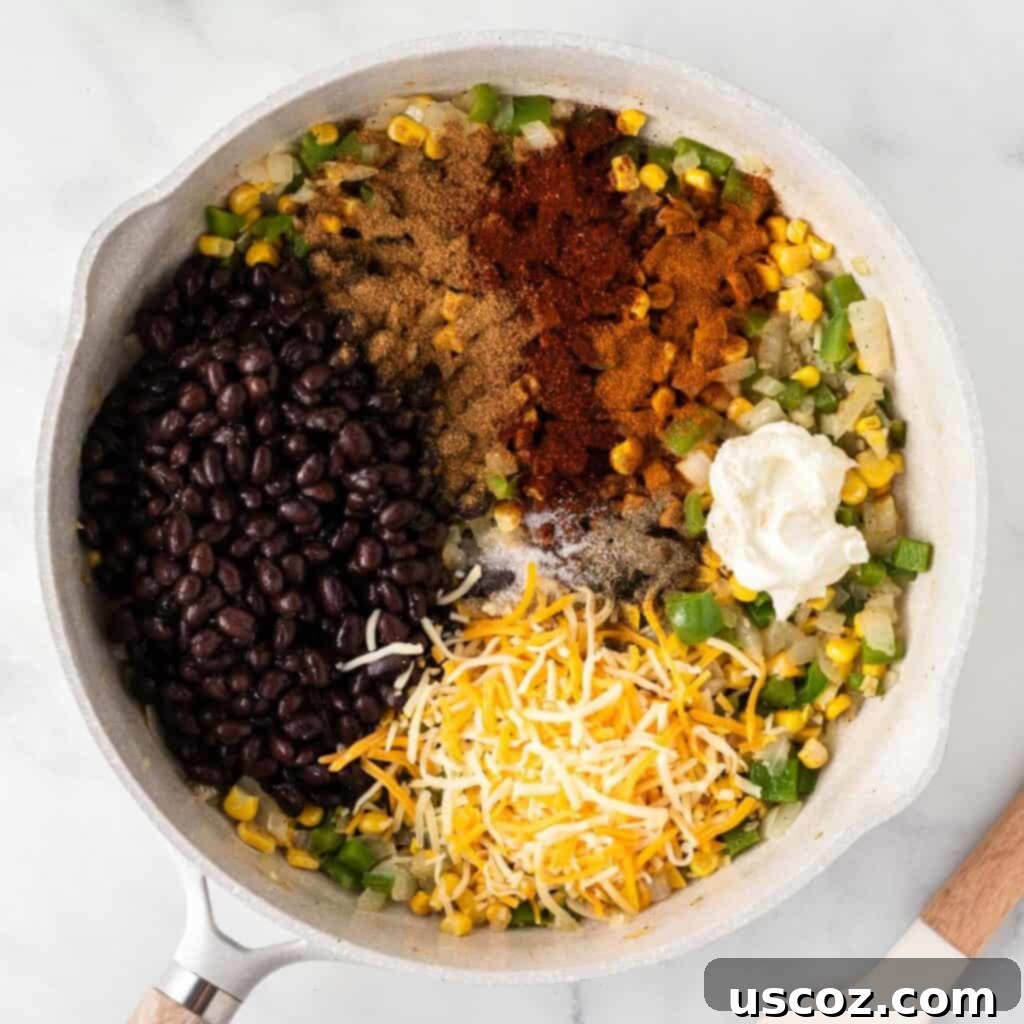 Irresistible Vegetarian Enchiladas 9 adding the black beans, cheese, cream cheese, and spices to the vegetables