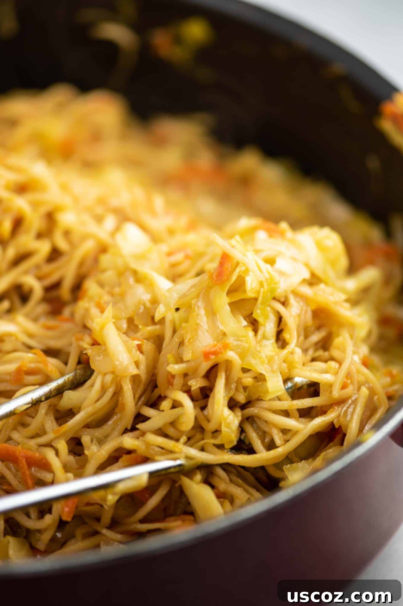 Savory Cabbage Stir Fry 10 cabbage stir fry in a skillet with tongs mixing the ingredients