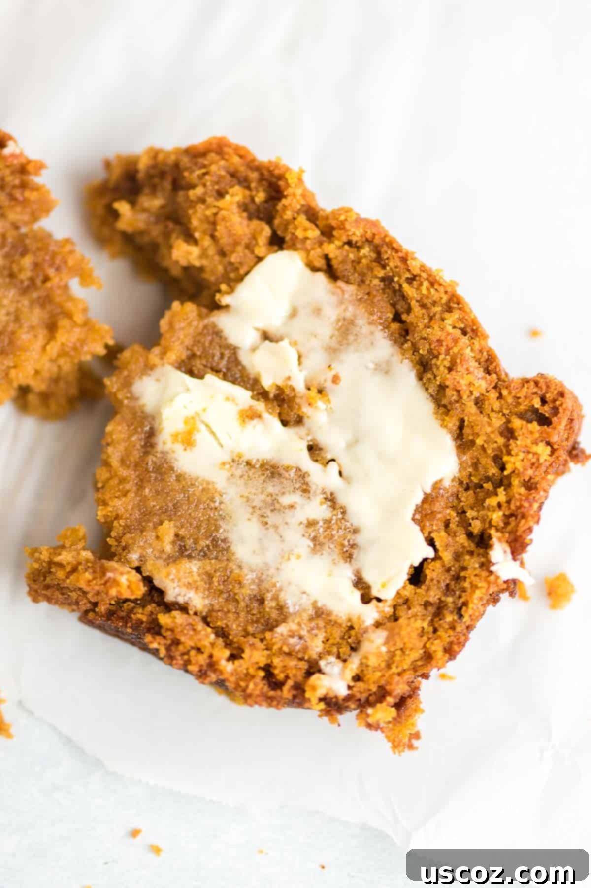 a slice of pumpkin bread from scratch smeared with melting butter