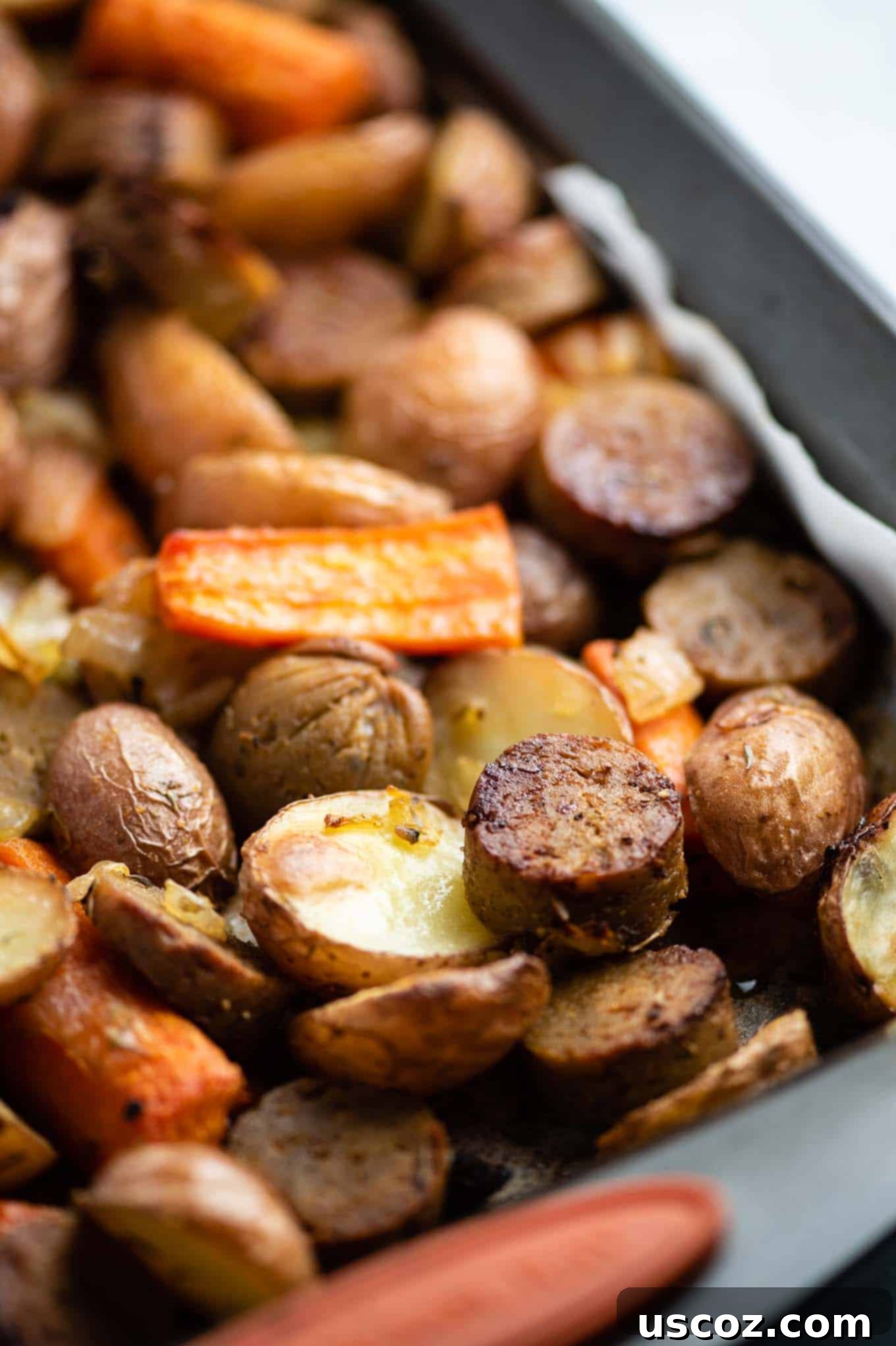 Close-up shot of perfectly roasted vegetarian kielbasa and potatoes, showing the delicious browning and crispy textures.