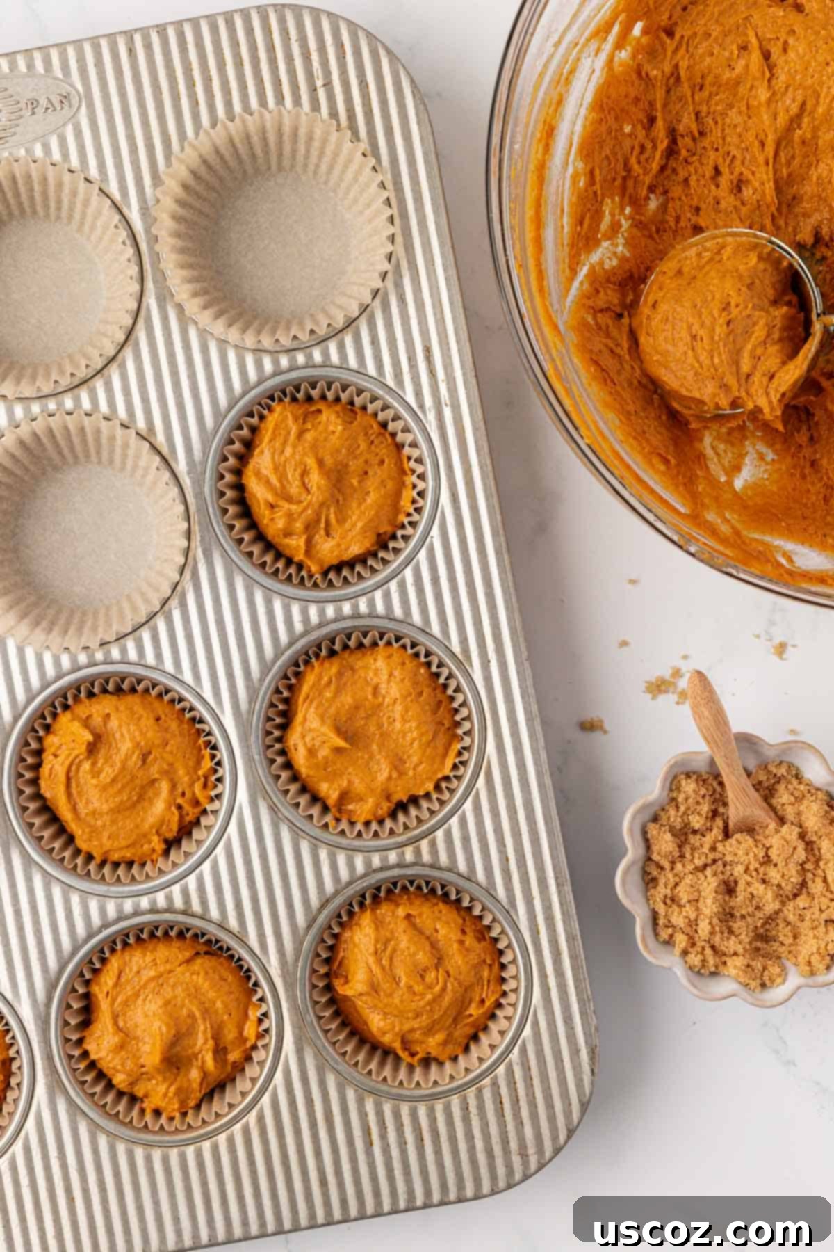 Effortless Cake Mix Pumpkin Muffins 7 pumpkin muffin batter in a lined muffin tin