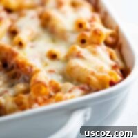 Ultimate Triple Cheese Baked Ziti 9 Baked ziti in a white casserole dish, featuring golden melted cheese and bubbling sauce