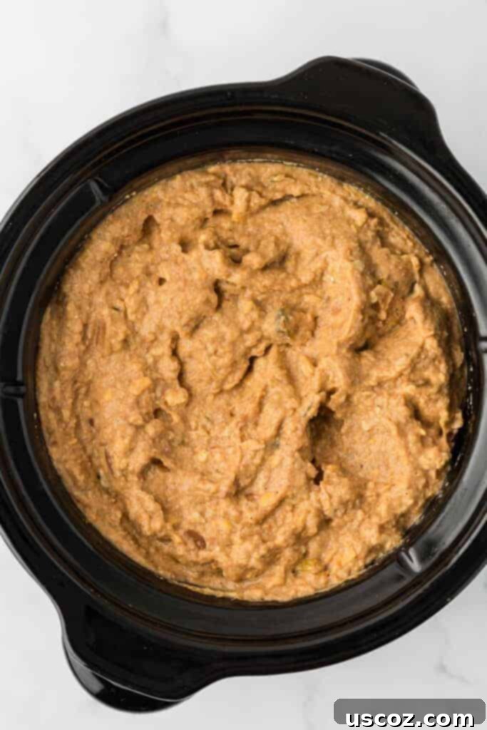 Slow Cooker Fiesta Bean Dip 6 bean dip in a black slow cooker