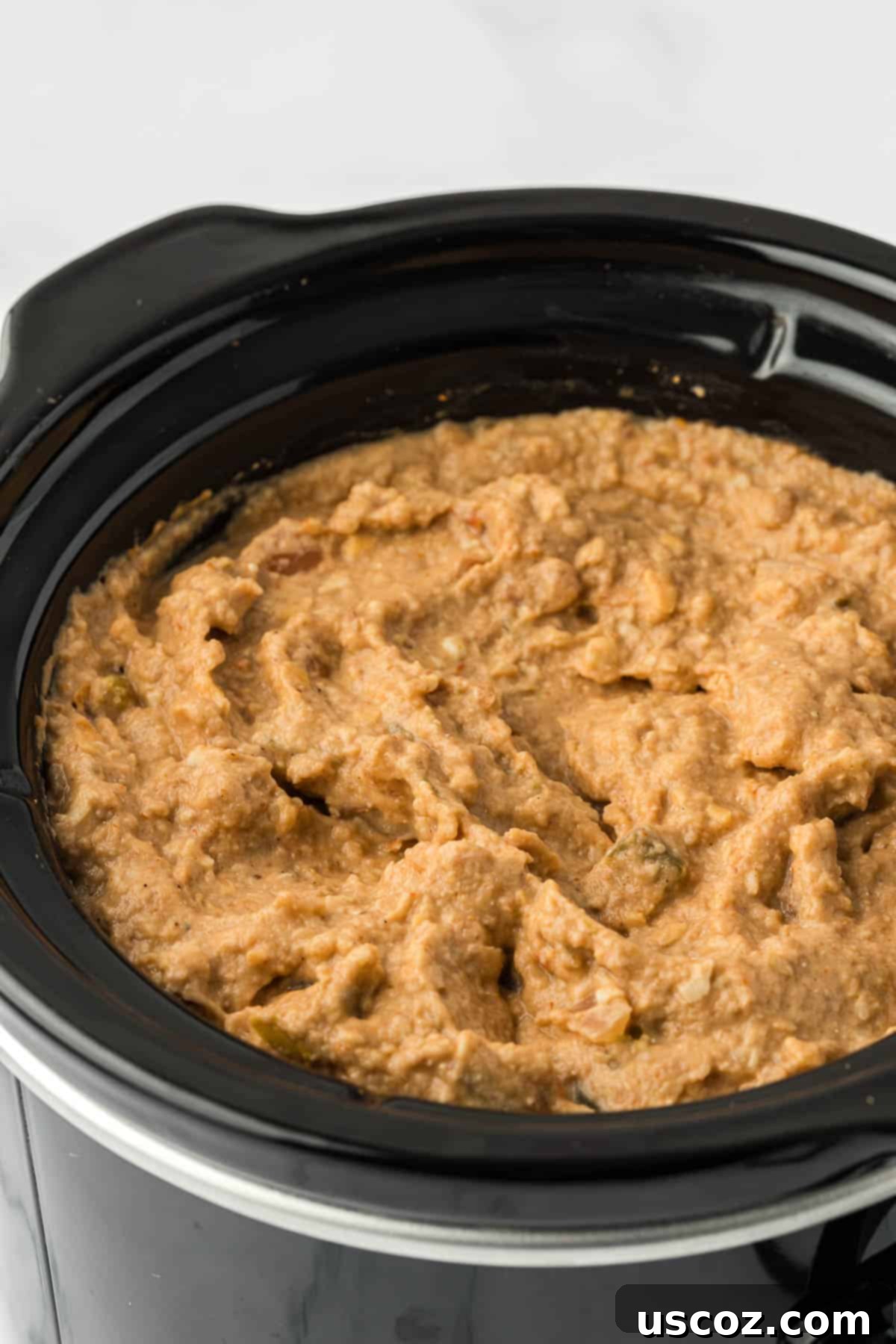 Slow Cooker Fiesta Bean Dip 8 bean dip in a black slow cooker