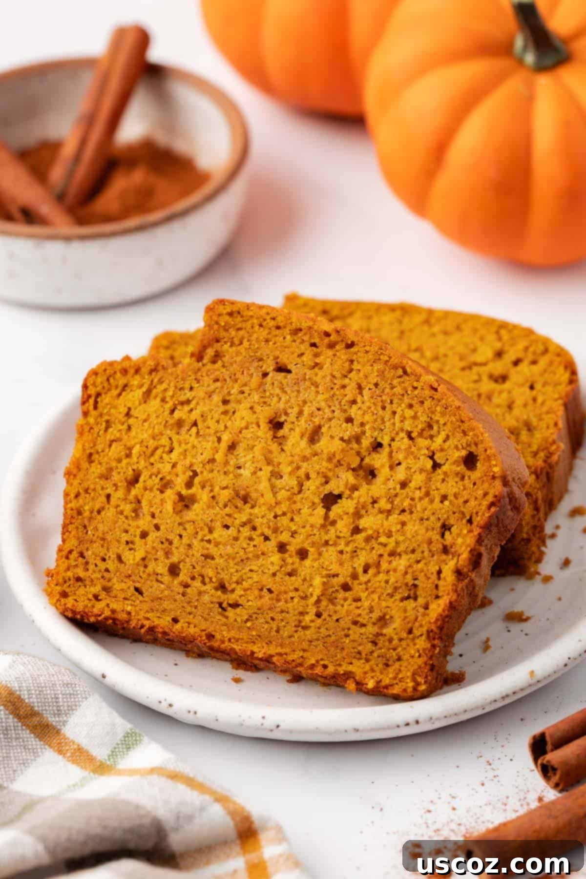 Effortless Cake Mix Pumpkin Bread 3 pumpkin bread slices on a plate