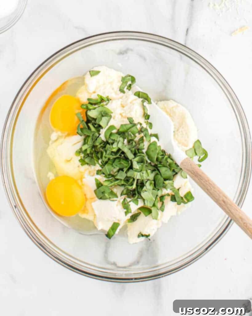 mixing together basil, ricotta, and eggs in a bowl