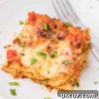 Classic Cheese Lasagna 30 A perfectly portioned slice of cheese lasagna on a white plate, showcasing its distinct layers of pasta, creamy ricotta, rich sauce, and melted mozzarella.