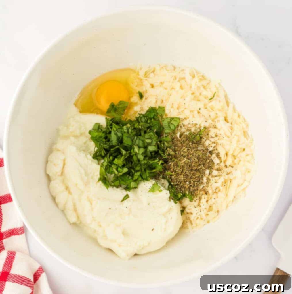 Classic Cheese Lasagna 8 All the ingredients for the rich ricotta cheese filling placed in a mixing bowl, including ricotta, egg, parmesan, oregano, and fresh basil, before being combined.