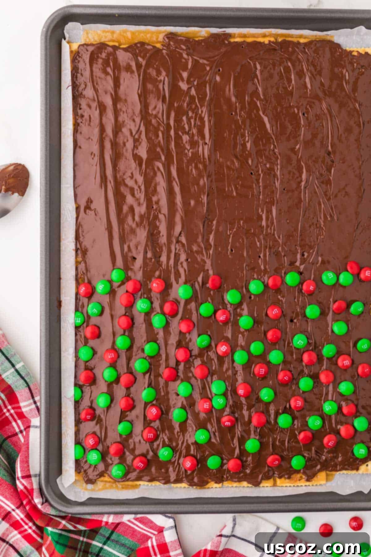 Christmas Cracker Toffee Recipe 12 melted chocolate spread over the crackers and half topped with red and green m&m's