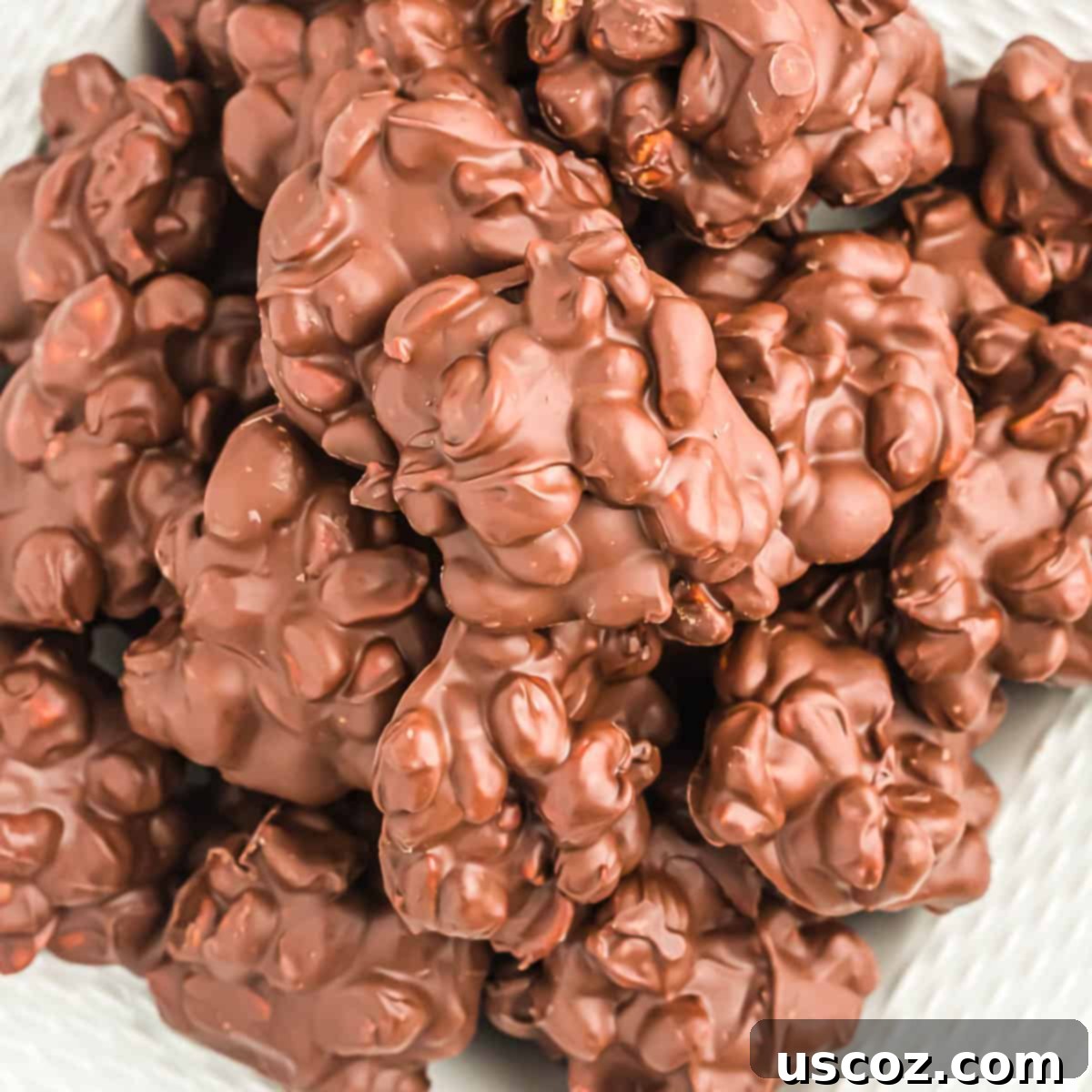 Crunchy Peanut Delights 2 Delicious chocolate peanut clusters arranged on a white serving platter, perfect for holiday gifting.