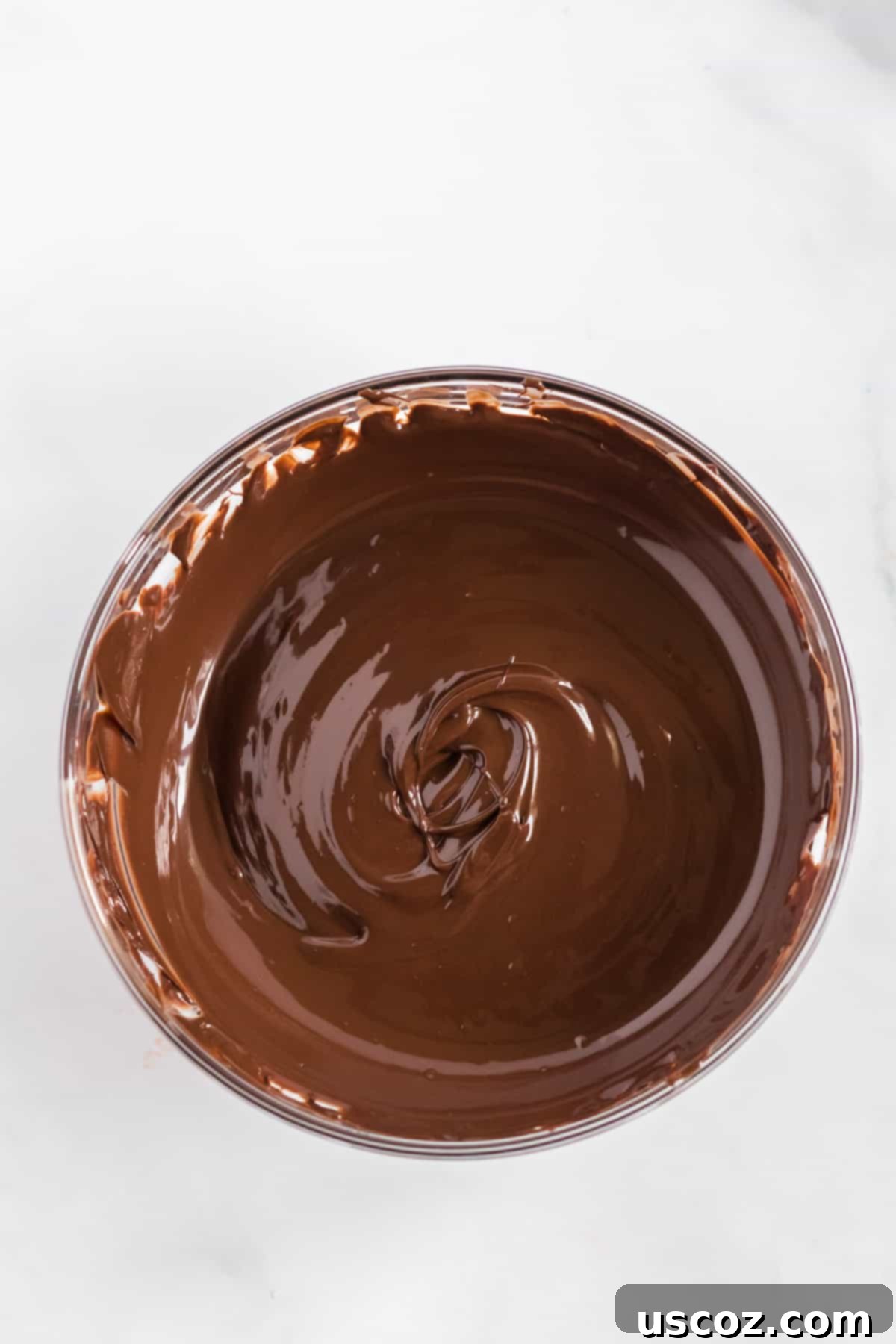 Crunchy Peanut Delights 5 A bowl of perfectly melted, smooth semi-sweet chocolate, ready for the peanuts.