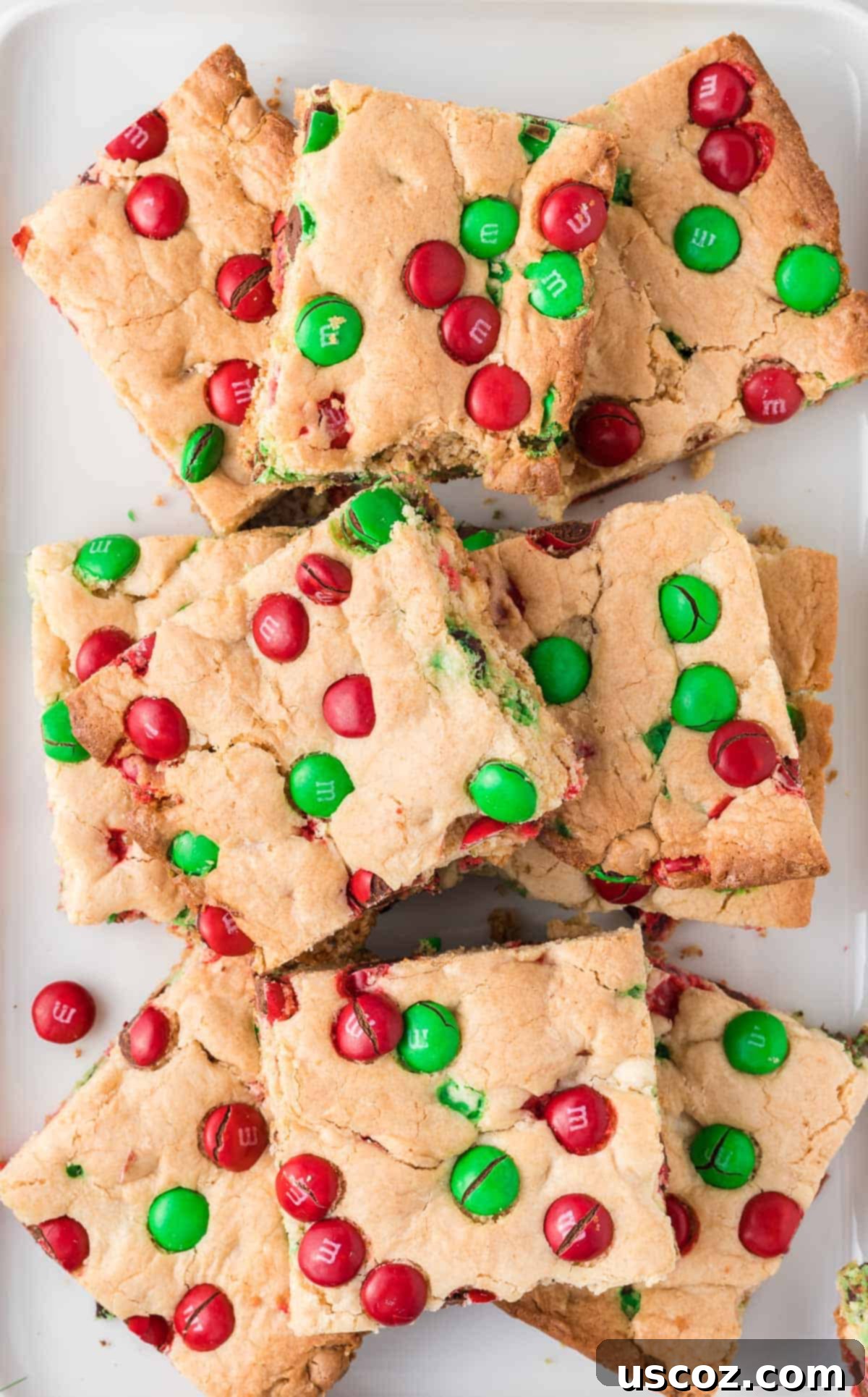 Merry Cookie Bar Magic 17 christmas cookie bars on a white plate, showcasing vibrant red and green M&M's