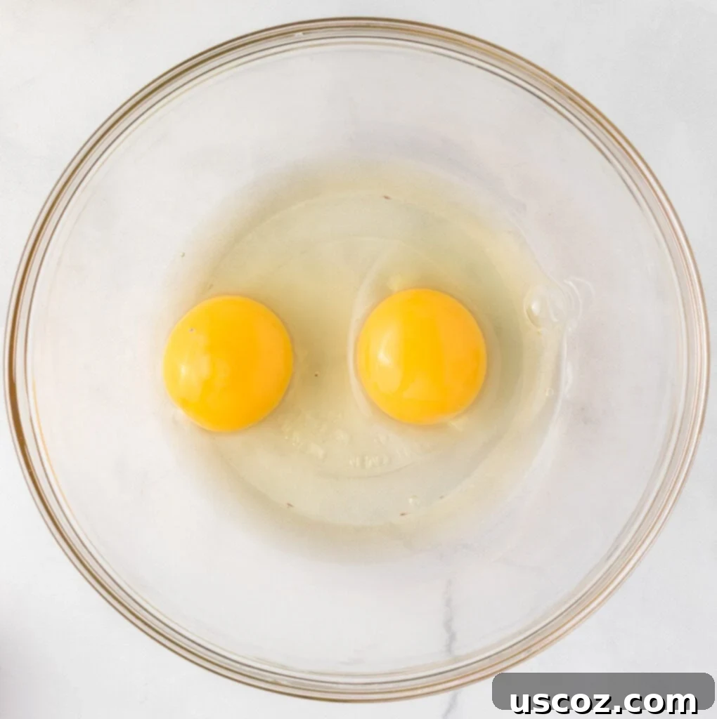 Merry Cookie Bar Magic 5 two eggs in a mixing bowl ready to be whisked
