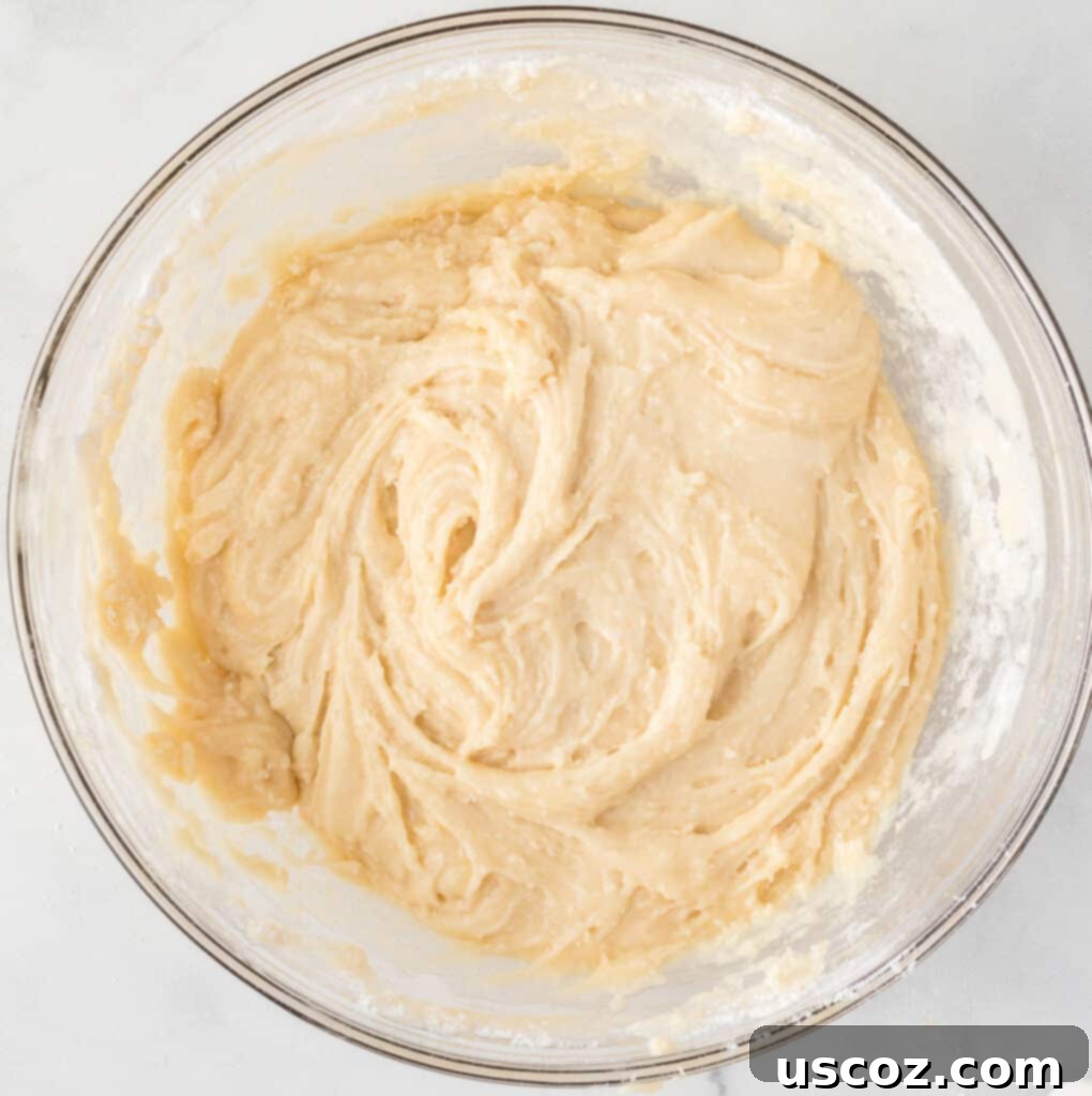 Merry Cookie Bar Magic 8 smooth cake mix cookie bar batter in a mixing bowl after combining ingredients
