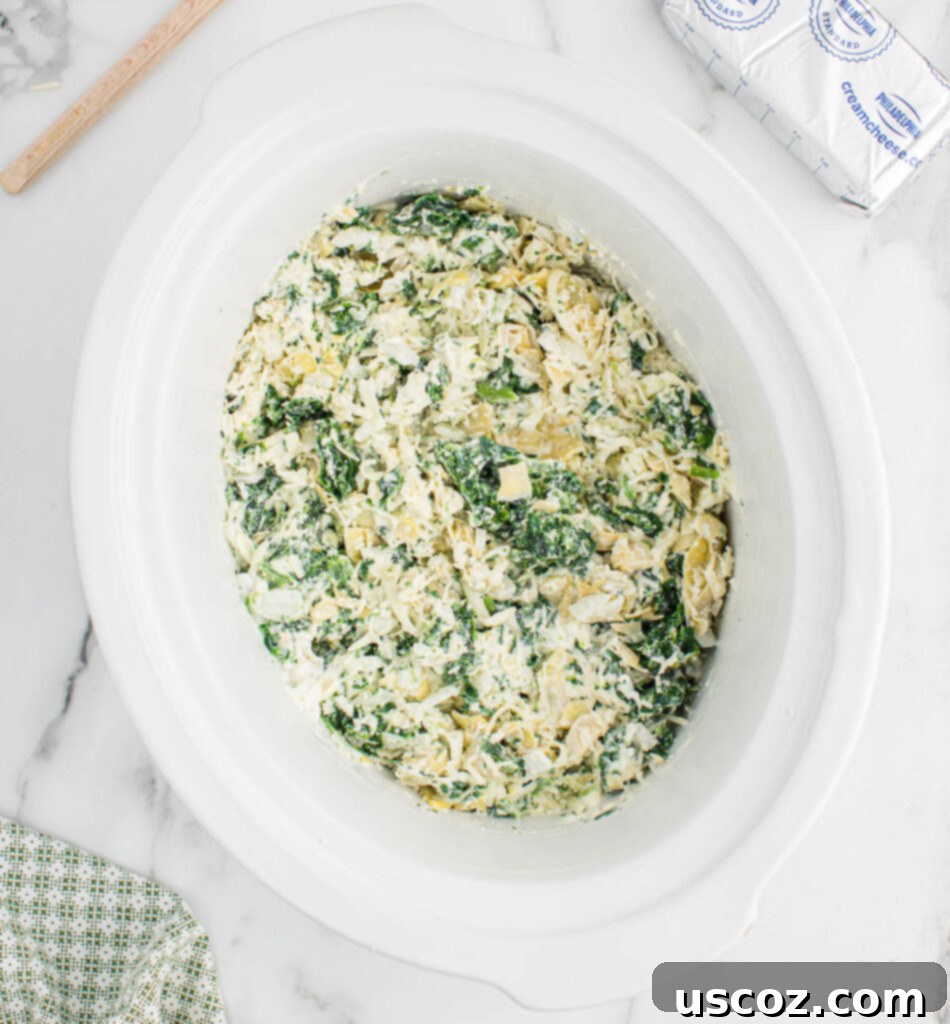 Creamy Slow Cooker Spinach Artichoke Dip 6 spinach artichoke dip in a crock pot